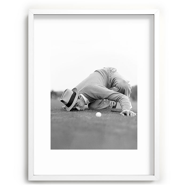 Eye to the ground on the 18th hole; golfing man eyes ball to measure distance to hole vintage black and white portrait photograph - photography - photographs poster Framed Art Print Gallery Image 107