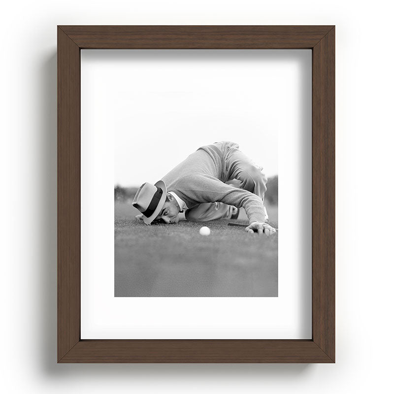 Eye to the ground on the 18th hole; golfing man eyes ball to measure distance to hole vintage black and white portrait photograph - photography - photographs poster Framed Art Print Gallery Image 88