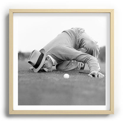 Eye to the ground on the 18th hole; golfing man eyes ball to measure distance to hole vintage black and white portrait photograph - photography - photographs poster Framed Art Print Gallery Image 109