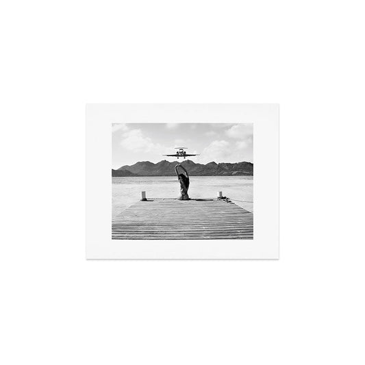 Steady as she goes girl in bikini on a dock with plane landing black and white photograph Art Print Gallery Image 1
